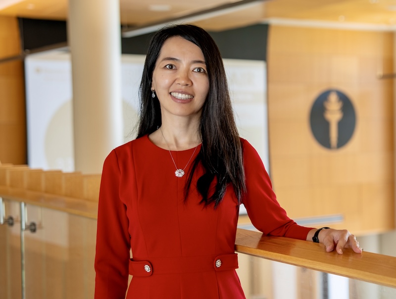 Rowan University professor of business and researcher Elly Qu standing in business hall