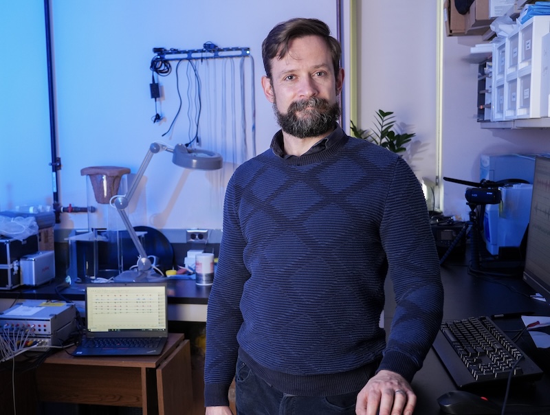 Francois Gould stands in his lab with medical imaging and testing equipment.