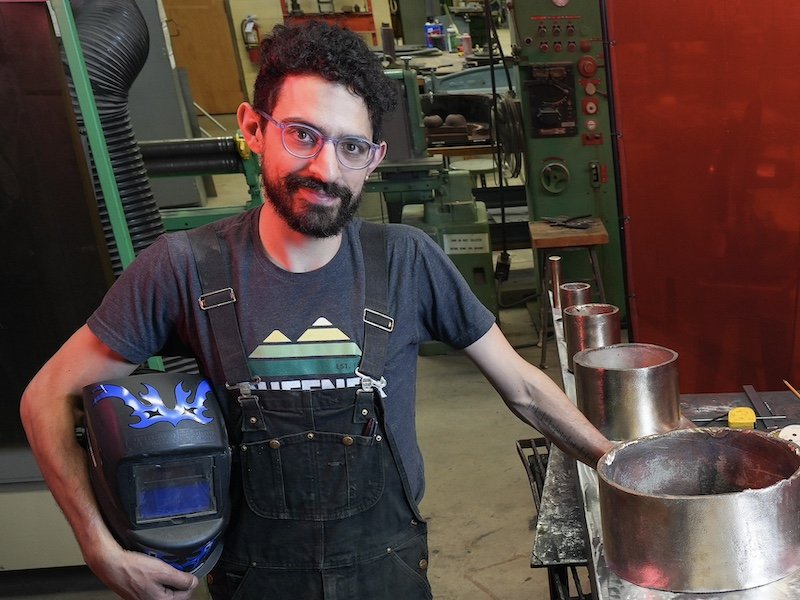 Sam Horowitz in sculpture studio with welding equipment