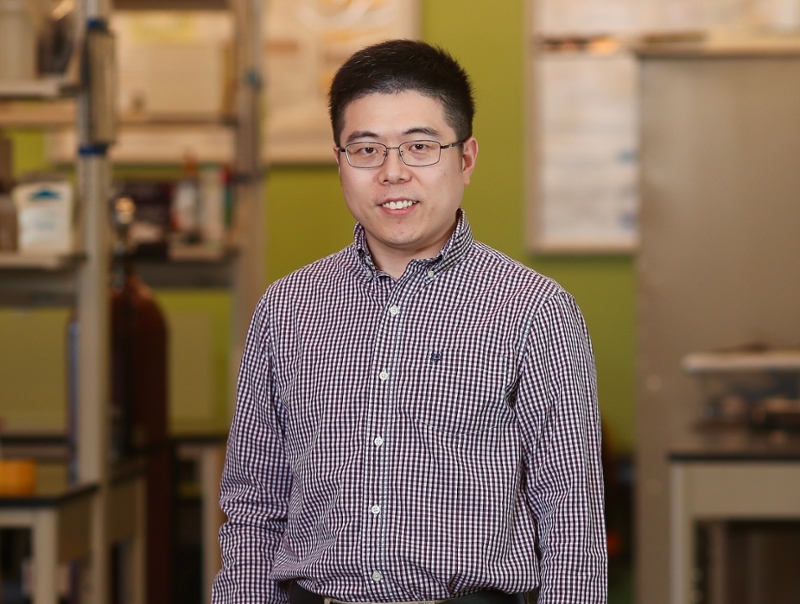 Rowan University professor and researcher Zhiming Zhang standing in an engineering lab.