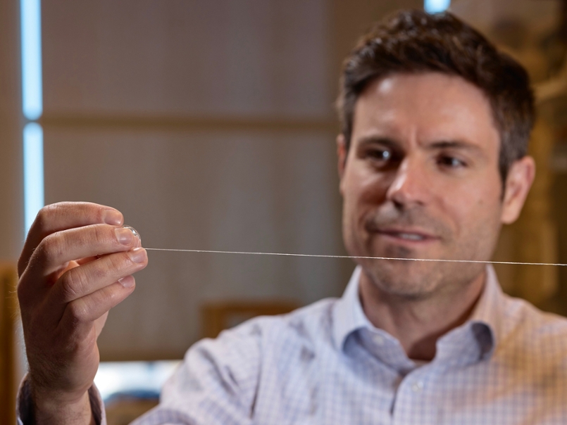 Vince Beachely hold a roll of nanofibers