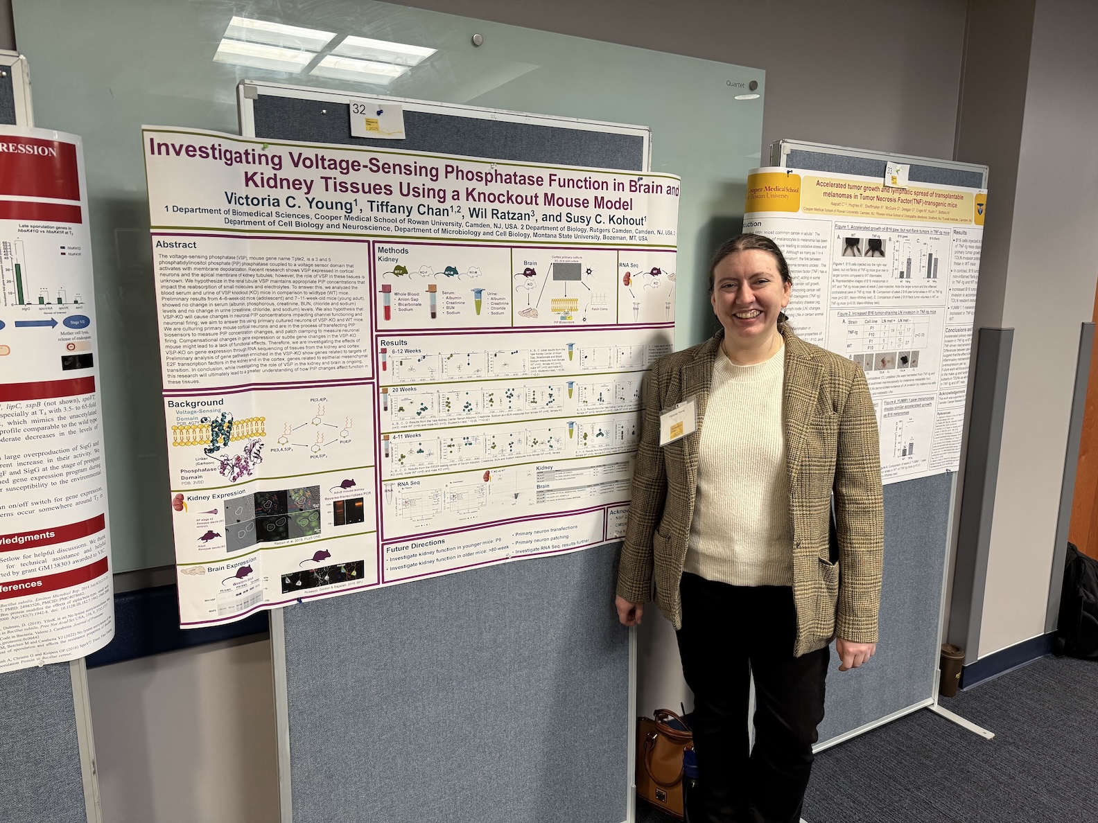 Victoria Young standing in front of her poster for Research Day at Rowan University 2025